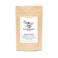 Kraft paper coffee package with a label featuring a dragonfly and coffee cup design on a white background.